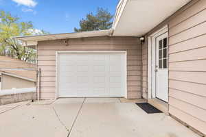 Garage featuring concrete driveway