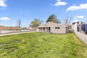 Rear view of house featuring a patio and a chimney