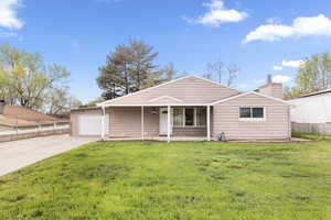 View of front of property featuring driveway and a chimney