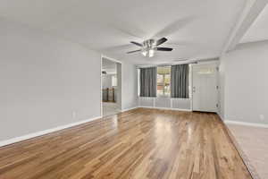 Unfurnished room with light wood-style flooring and a ceiling fan