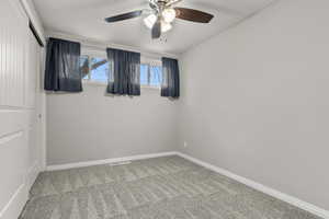 Spare room with light carpet and ceiling fan