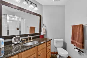 Full bathroom featuring vanity and a shower stall