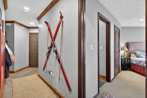 Corridor featuring baseboards and recessed lighting