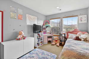 Bedroom featuring light carpet
