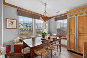 Dining space with a mountain view and dark tile patterned flooring