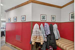 Detailed view of ornamental molding and a wainscoted wall