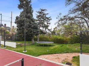 View of yard featuring a fenced backyard and a trampoline