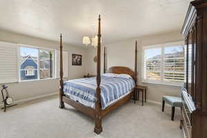 Bedroom with light colored carpet and baseboards