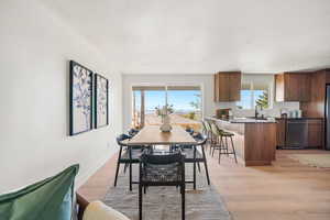 Dining space featuring light wood-type flooring and baseboards