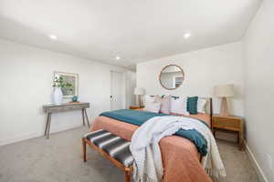 Bedroom with light carpet and recessed lighting