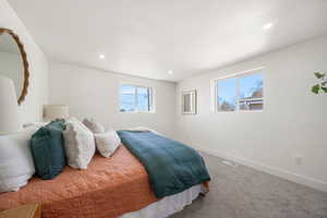 Bedroom with carpet floors, multiple windows, and recessed lighting