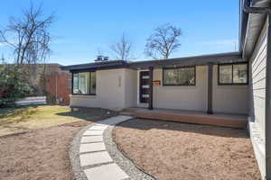View of front of house with brick siding and a front yard