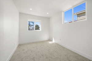 Unfurnished room featuring light colored carpet and recessed lighting