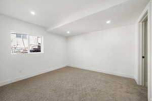 Carpeted spare room featuring recessed lighting and baseboards
