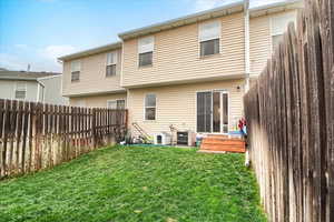 Rear view of house with a fenced backyard