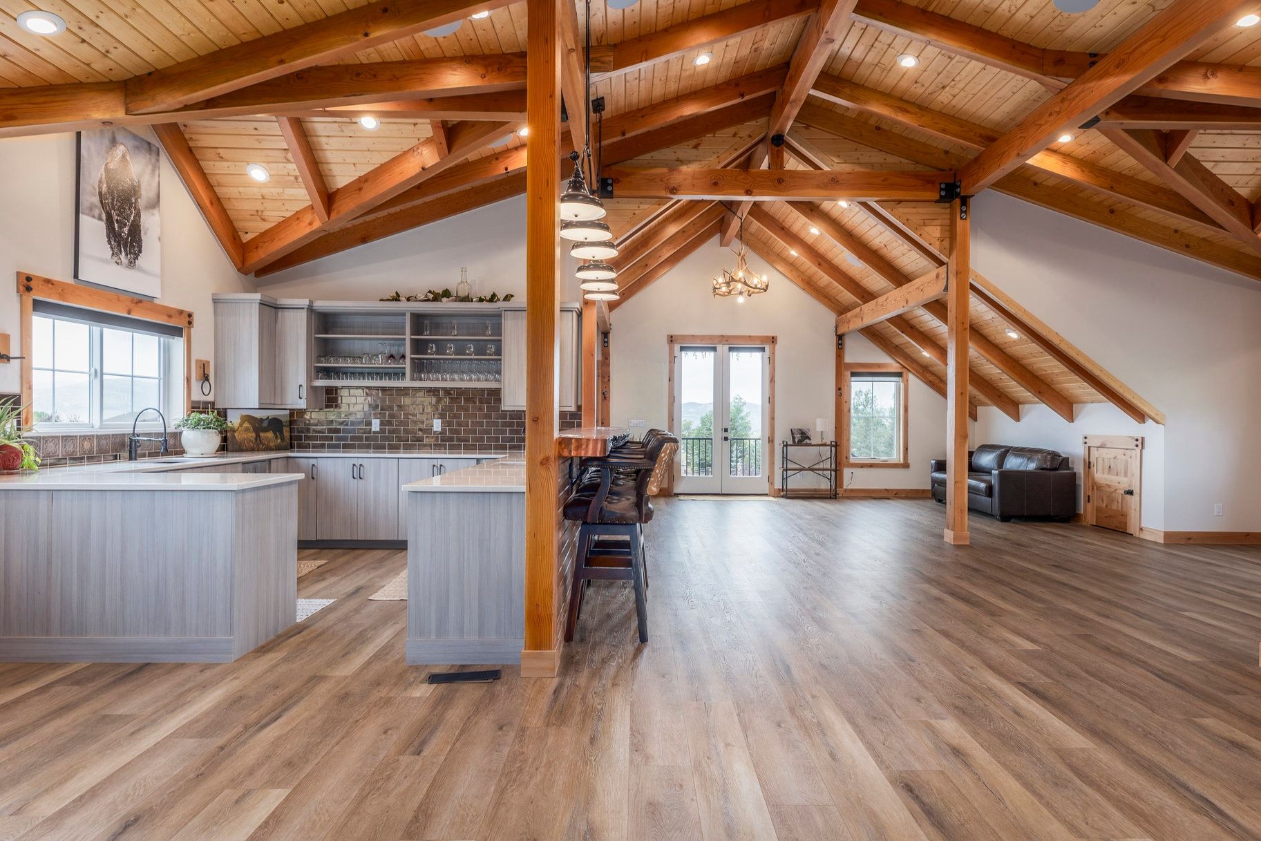 Kitchen featuring a peninsula, french doors, open floor plan, a high wood beamed ceiling, and open shelves