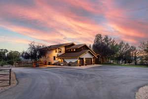 View of front of house with driveway, a tiled roof, and stucco siding