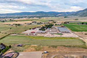 Aerial view of property's location with rural landscape and mountains