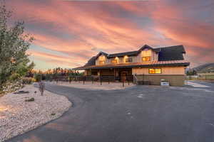 View of front of property with an exterior structure, board and batten siding, an outdoor structure, and a metal roof