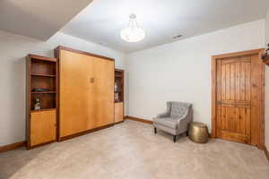 Unfurnished room featuring light carpet and baseboards