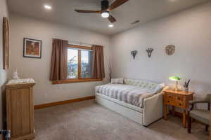 Bedroom with light carpet, a ceiling fan, and recessed lighting