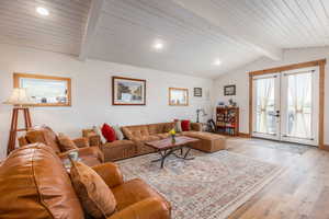Living room with french doors, hardwood / wood-style floors, a wooden ceiling with exposed beams, and recessed lighting
