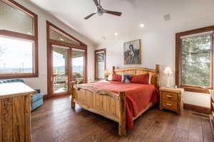 Bedroom with access to exterior, dark wood finished floors, ceiling fan, a mountain view, and lofted ceiling