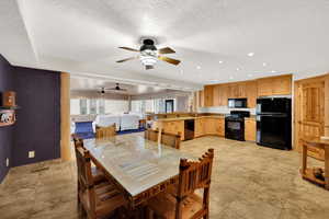 Dining area featuring a textured ceiling, a ceiling fan, and recessed lighting