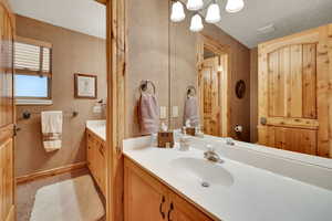 Bathroom featuring vanity and a textured ceiling