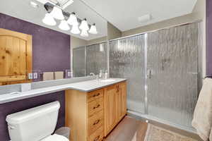 Full bathroom featuring vanity and a shower stall