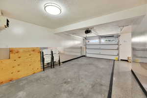 Garage featuring a heating unit and a garage door opener