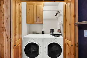 Laundry room featuring cabinet space and separate washer and dryer