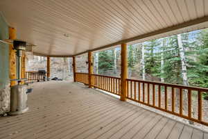 Wooden deck featuring a grill