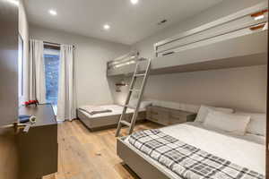 Bedroom with light wood finished floors and recessed lighting