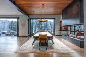 Dining area featuring recessed lighting, wooden ceiling, light wood-style flooring, and healthy amount of natural light