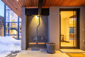 Property entrance featuring stucco siding and a patio