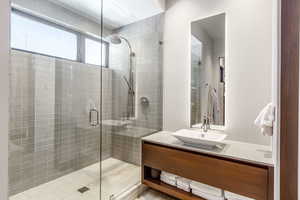 Bathroom featuring a shower stall and vanity