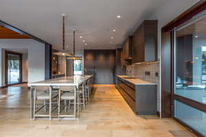 Kitchen with healthy amount of natural light, modern cabinets, and light stone counters