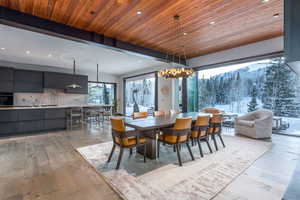 Dining space featuring wooden ceiling, light wood-type flooring, and a chandelier