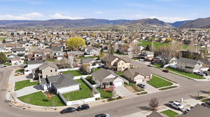 Aerial view of property's location with mountains and nearby suburban area