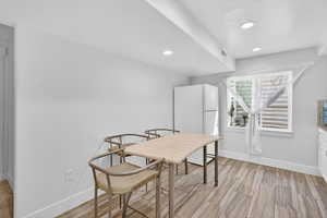 Dining room featuring recessed lighting and wood tiled floors