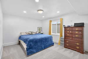 Carpeted bedroom with baseboards and recessed lighting