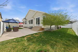 Rear view of property with a fenced backyard, entry steps, a patio area, and a gate
