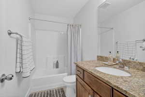 Bathroom with vanity and shower / bathtub combination with curtain