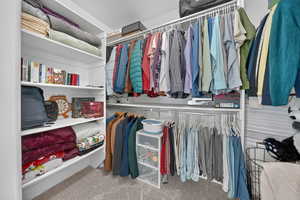 Walk in closet with light carpet