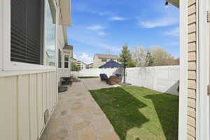 Fenced backyard with a patio, an outdoor living space, and a residential view
