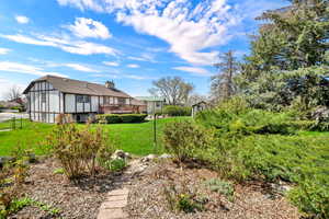 View of grassy yard featuring a deck