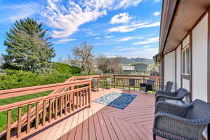 Wooden terrace featuring a mountain view
