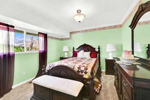 Bedroom featuring light carpet and ornamental molding