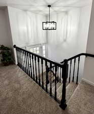 New door, chandelier, and freshly painted railings